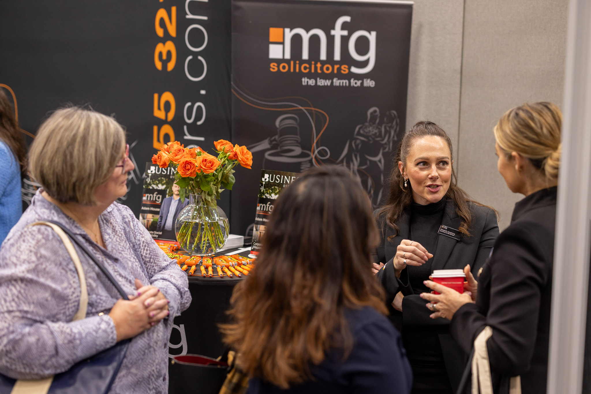 two men in building yard with hard hats, shaking hands