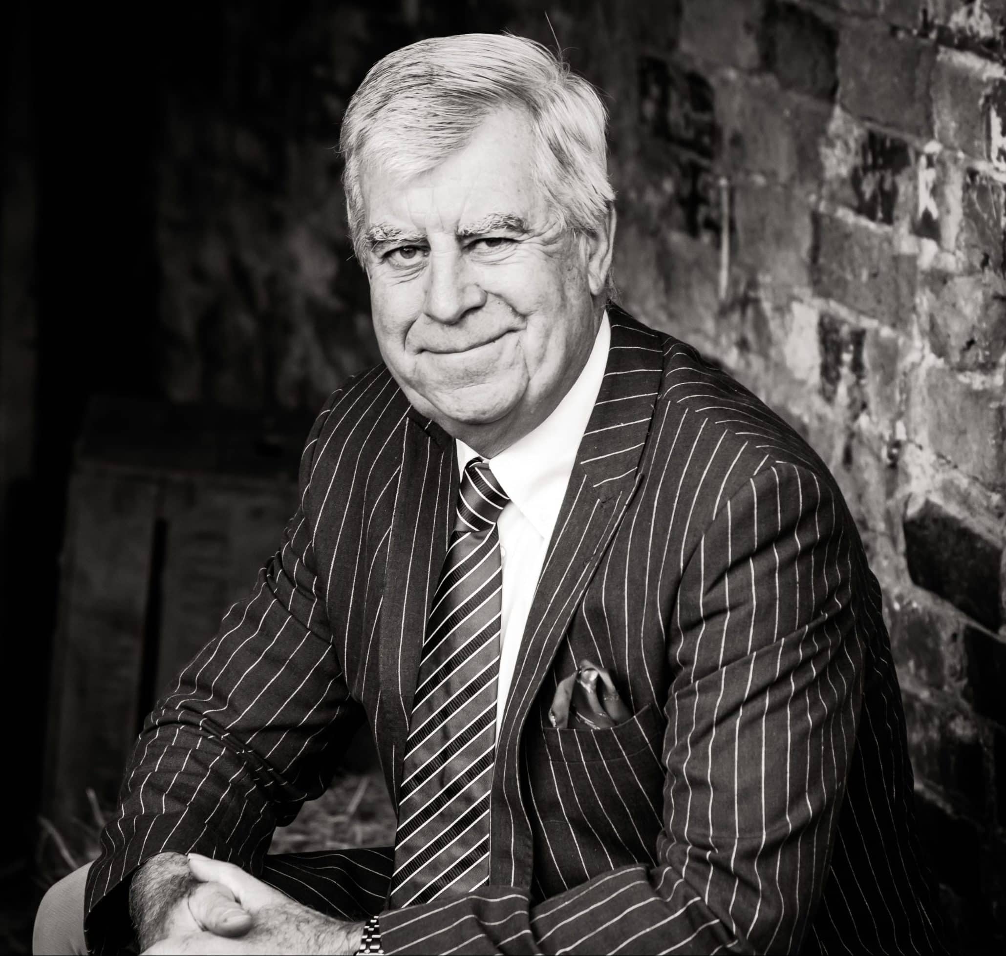 FORRESTER2-4-2 (1) two men in building yard with hard hats, shaking hands